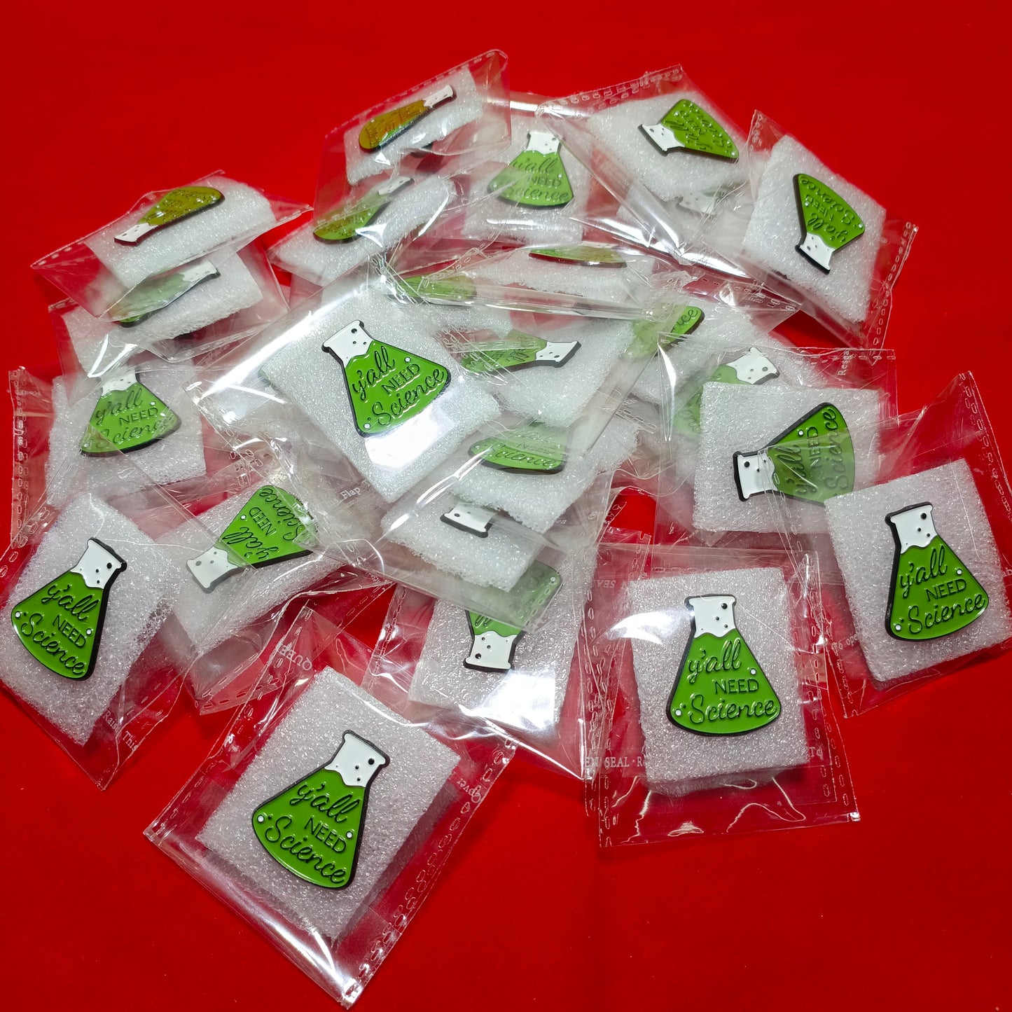 Lapel pins of beaker green