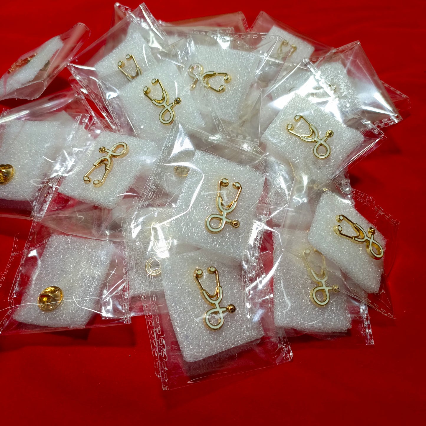 Lapel pins of stethoscope gold white