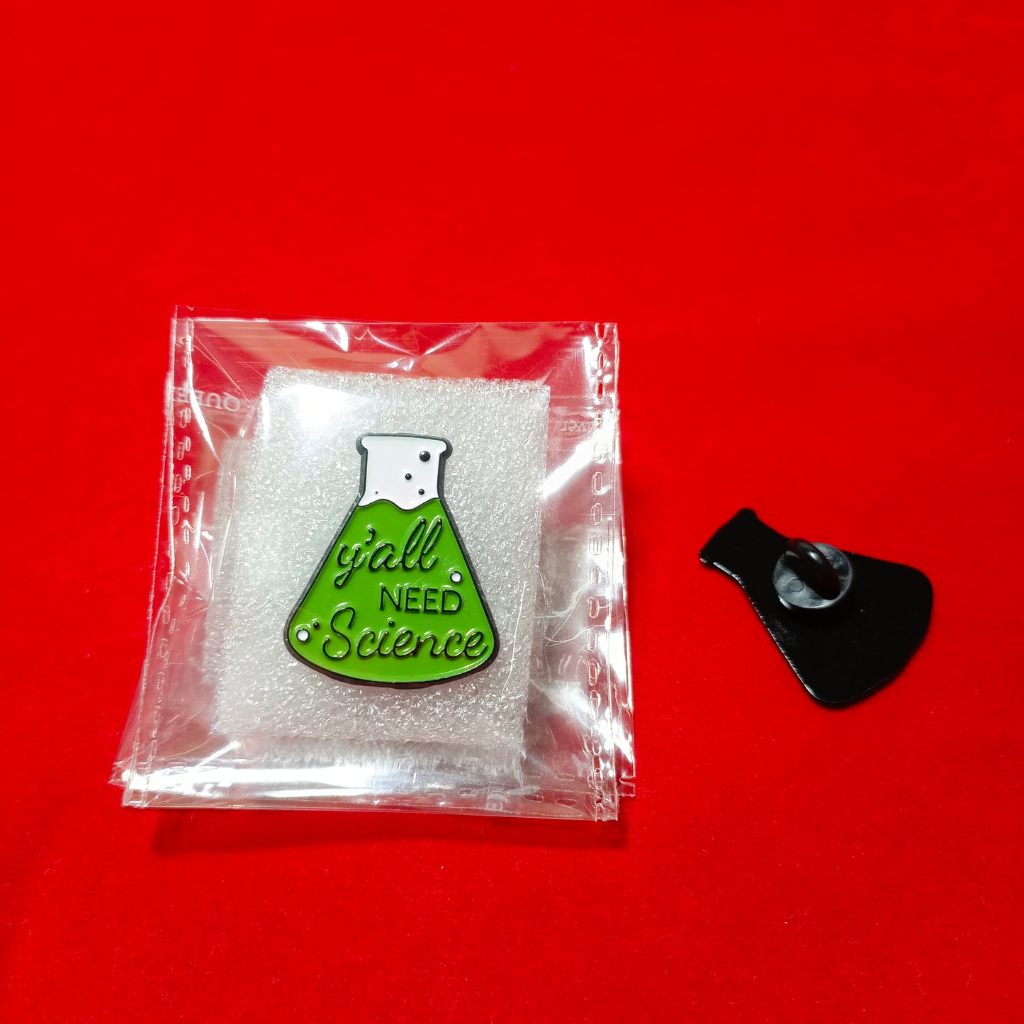 Lapel pins of beaker green