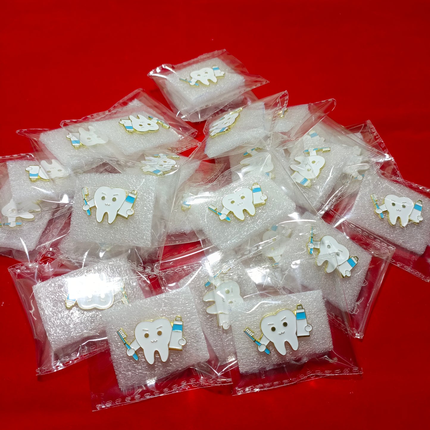 Lapel pins of tooth cartoon with paste & brush