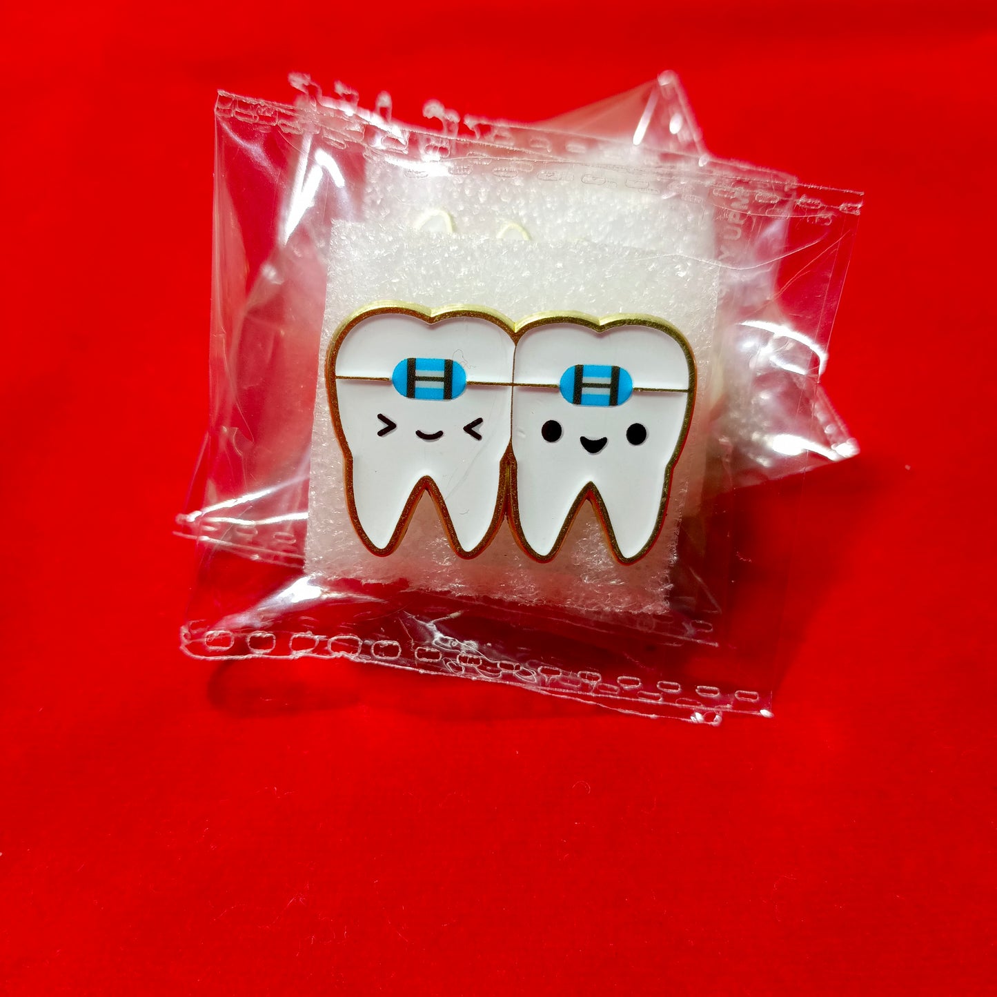 Lapel pins of tooth with braces