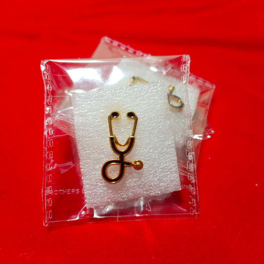 Lapel pins of stethoscope black on gold