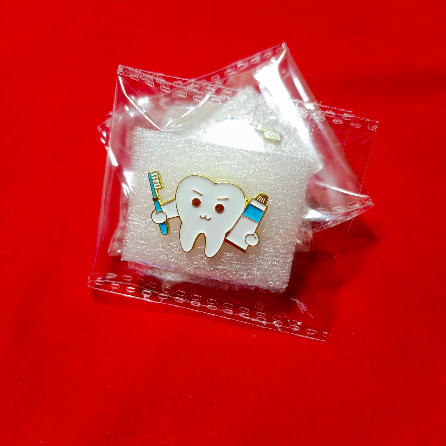 Lapel pins of tooth cartoon with paste & brush