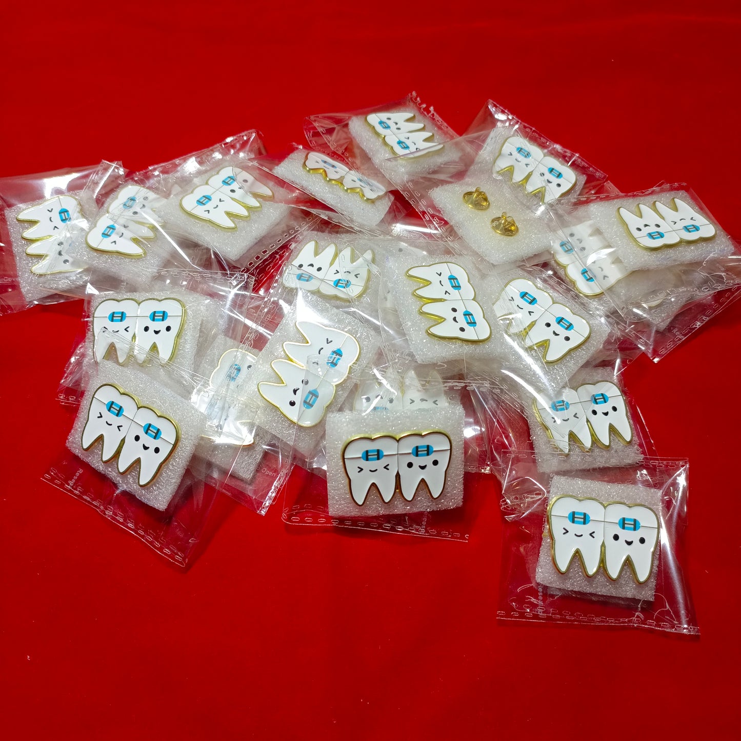 Lapel pins of tooth with braces