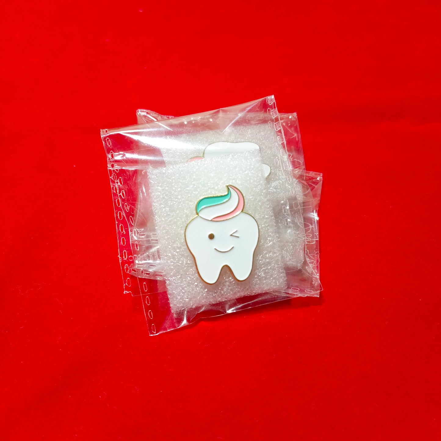 Lapel pins of smiling tooth cartoon