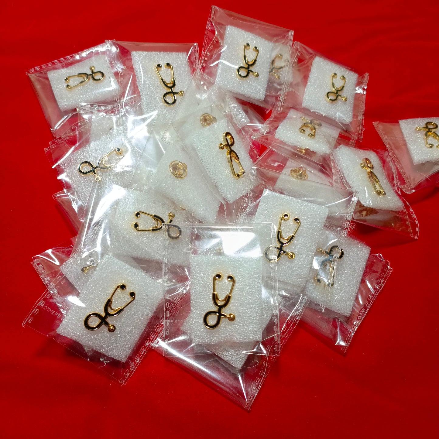 Lapel pins of stethoscope black on gold