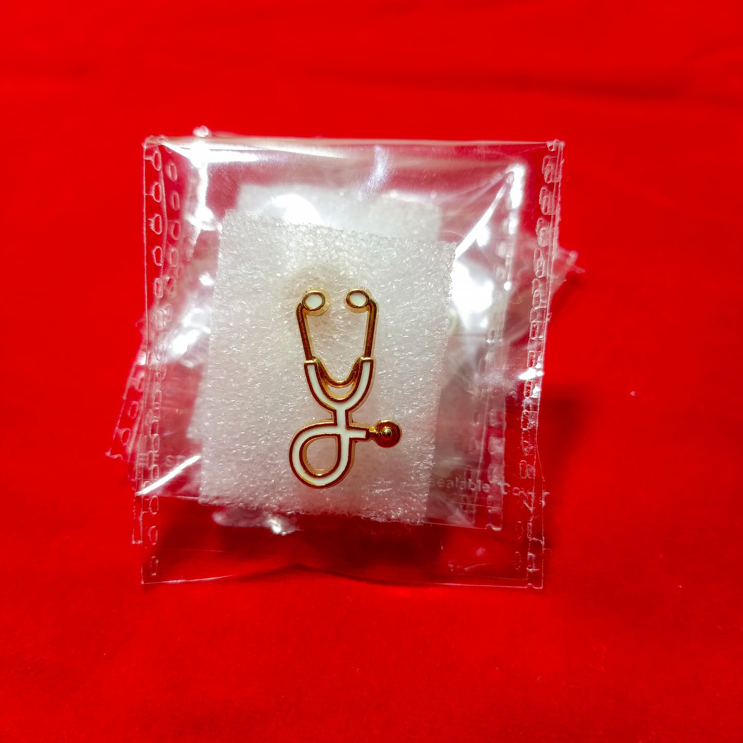 Lapel pins of stethoscope gold white